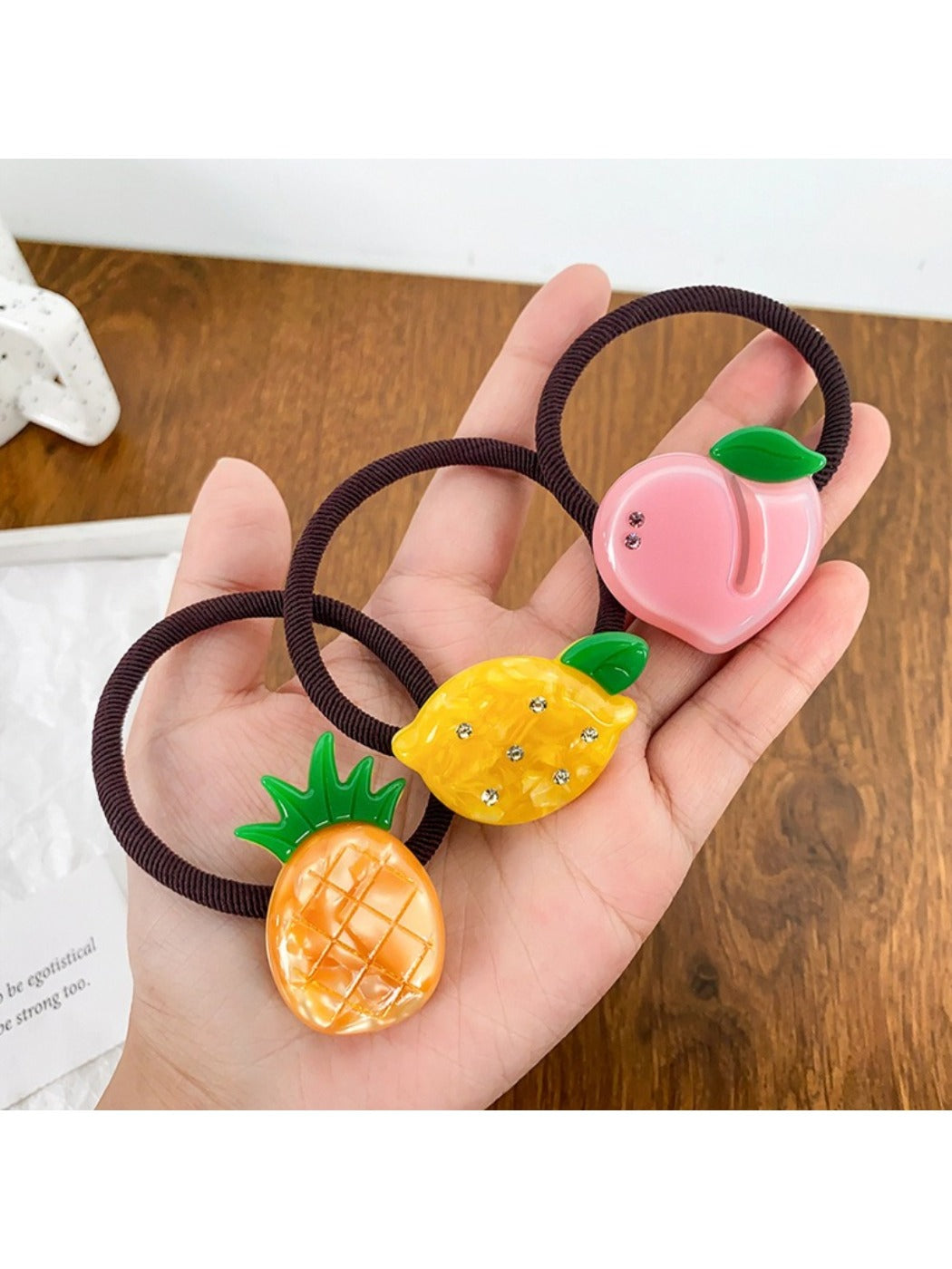 Yellow hair tie decorated with a lemon slice charm