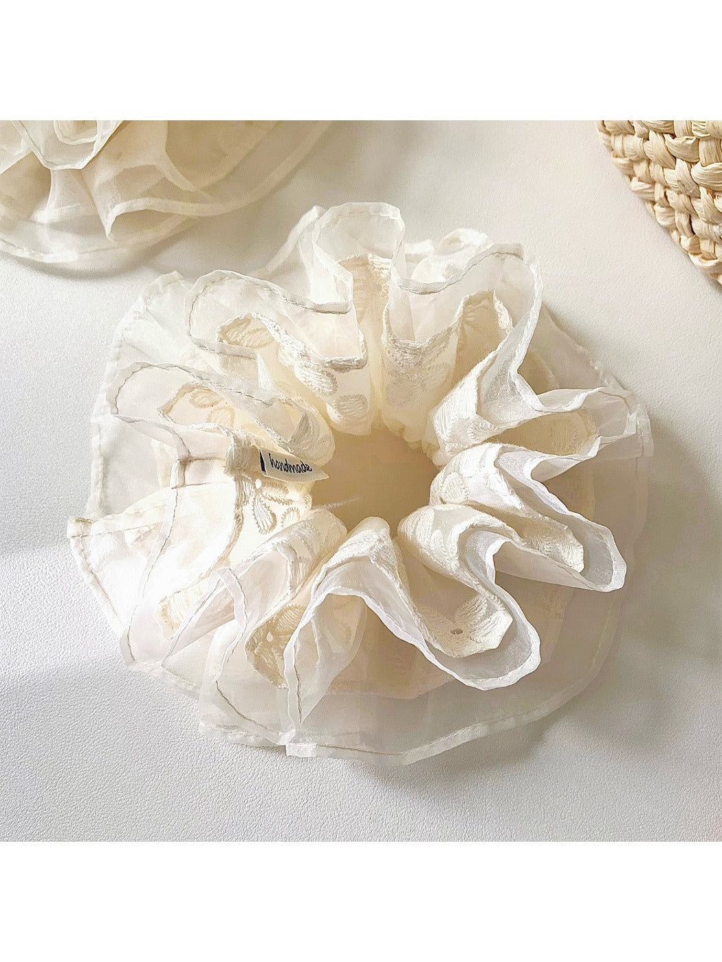 Gifty tulle scrunchie wrapped around a ponytail on a model with blonde hair