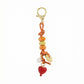 Keypus vintage beaded bag charm attached to a handbag handle