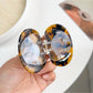 Beau cat hair claw clip held in hand to show size and shape