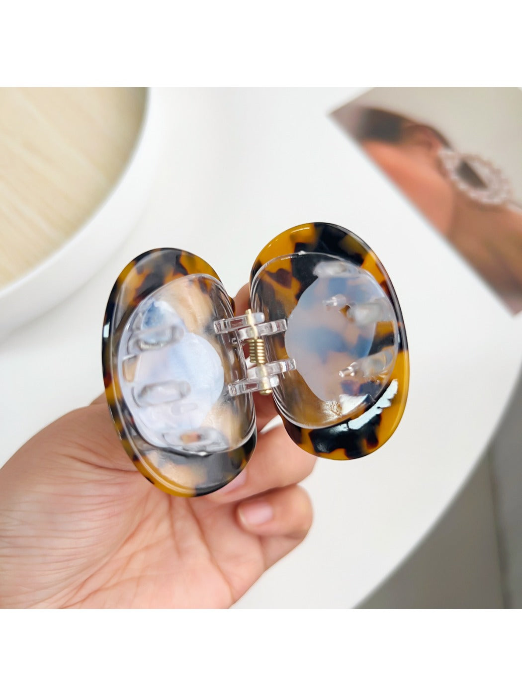 Beau cat hair claw clip held in hand to show size and shape