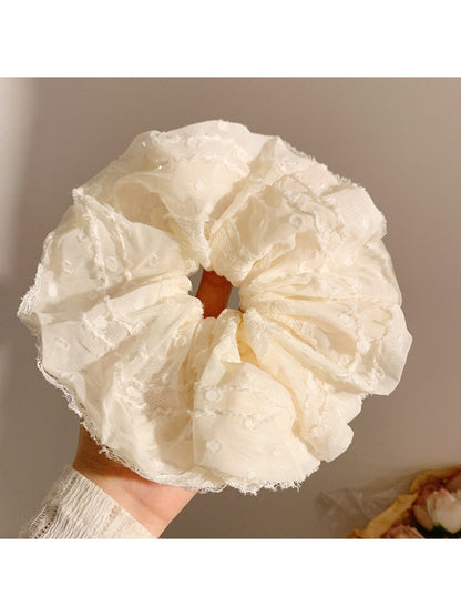 Set of Gifty scrunchies in various classic pastel colors displayed on white background
