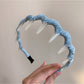 Gifty polka dot toothed comb headband displayed on a white background