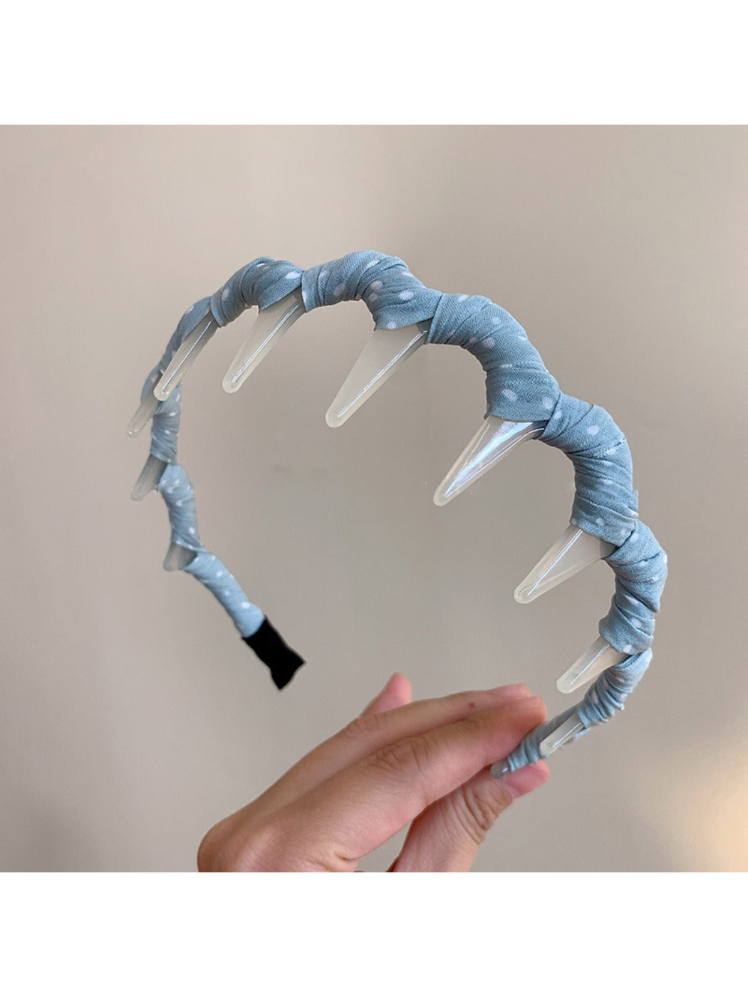 Gifty polka dot toothed comb headband displayed on a white background