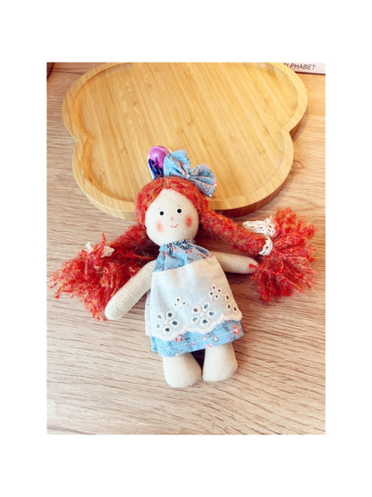 Keypus cartoon doll keychain hanging from a handbag strap