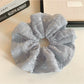 Gifty scrunchie wrapped around a ponytail, highlighting its ruffled design