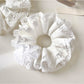 Close-up of white lace trim detail on the Gifty scrunchie