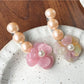 Side view of Beau Camellia shaped hair clip with pearl-like beads