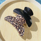 Side view of Beau black glitter and leopard claw clip with open teeth