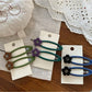 Side view of Beau hair clip featuring colorful flower pattern and metal clasp