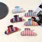 Beau colorful striped half moon claw clip on white background