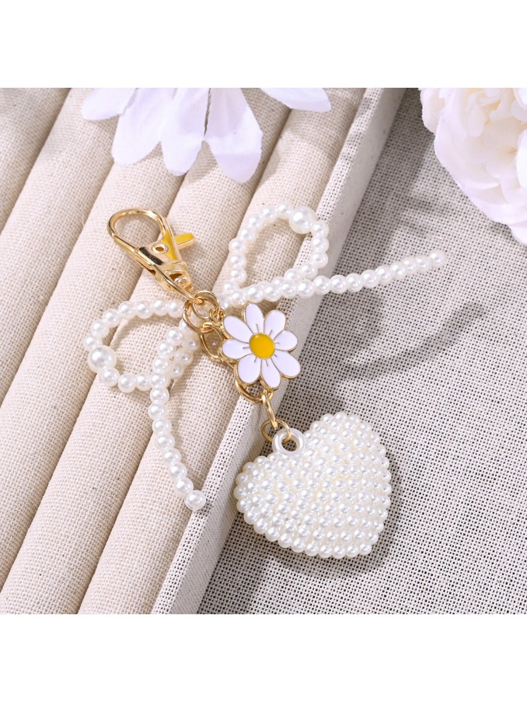 Keypus bow heart shaped keychain attached to a set of keys