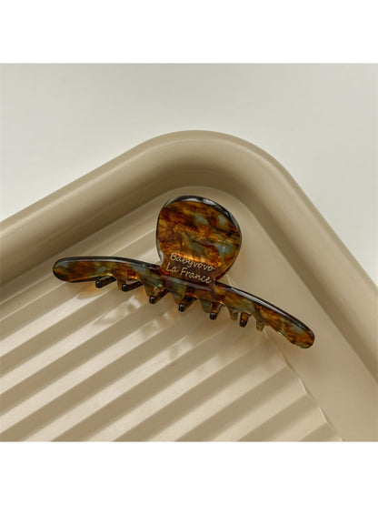 Top view of Beau brown acetate claw clip showing smooth rounded edges