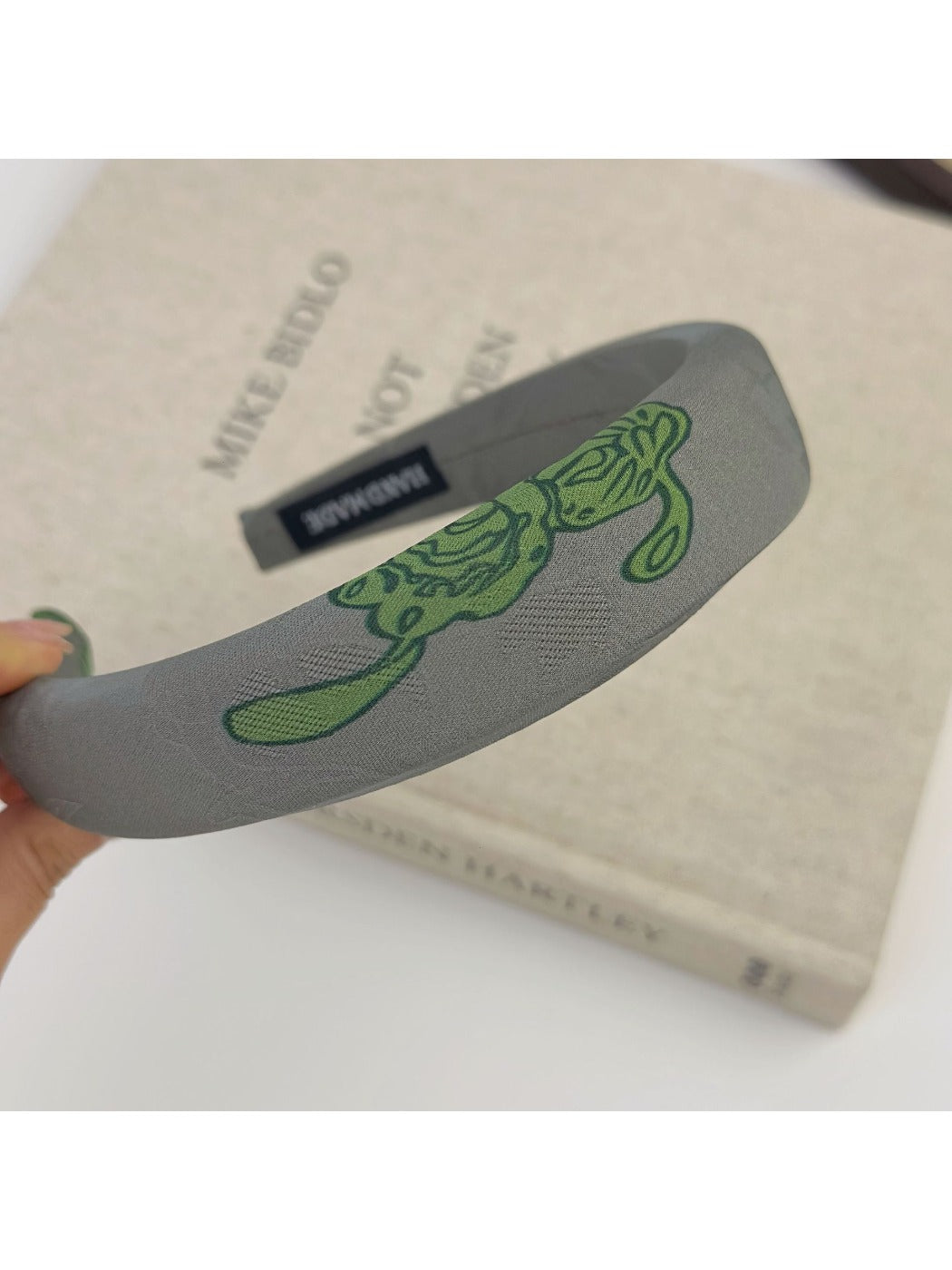 Side angle of Gifty embroidered flower headband showing flower arrangement
