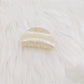 Beau claw clip shown from angled perspective highlighting marble texture