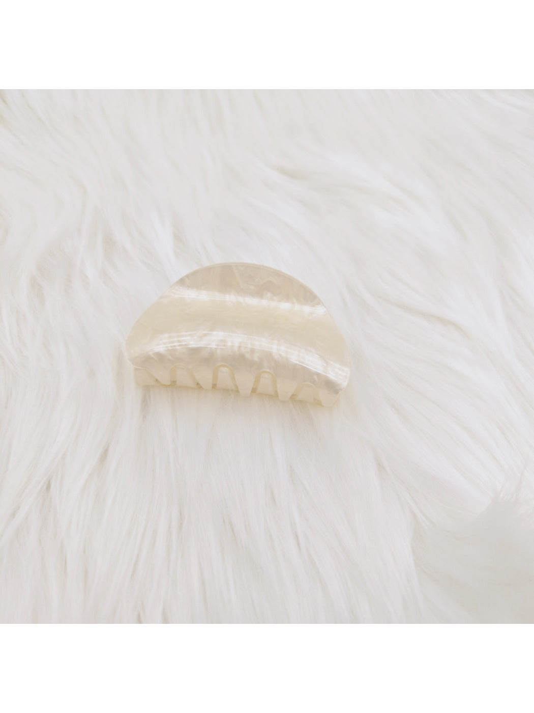 Beau claw clip shown from angled perspective highlighting marble texture