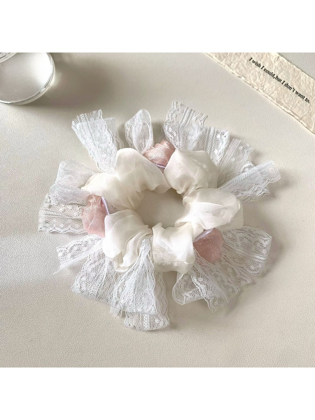 Gifty floral scrunchie in a flat lay with matching accessories and neutral tones