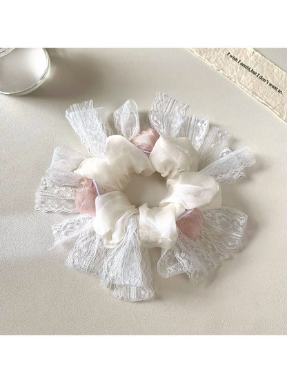 Gifty floral scrunchie in a flat lay with matching accessories and neutral tones