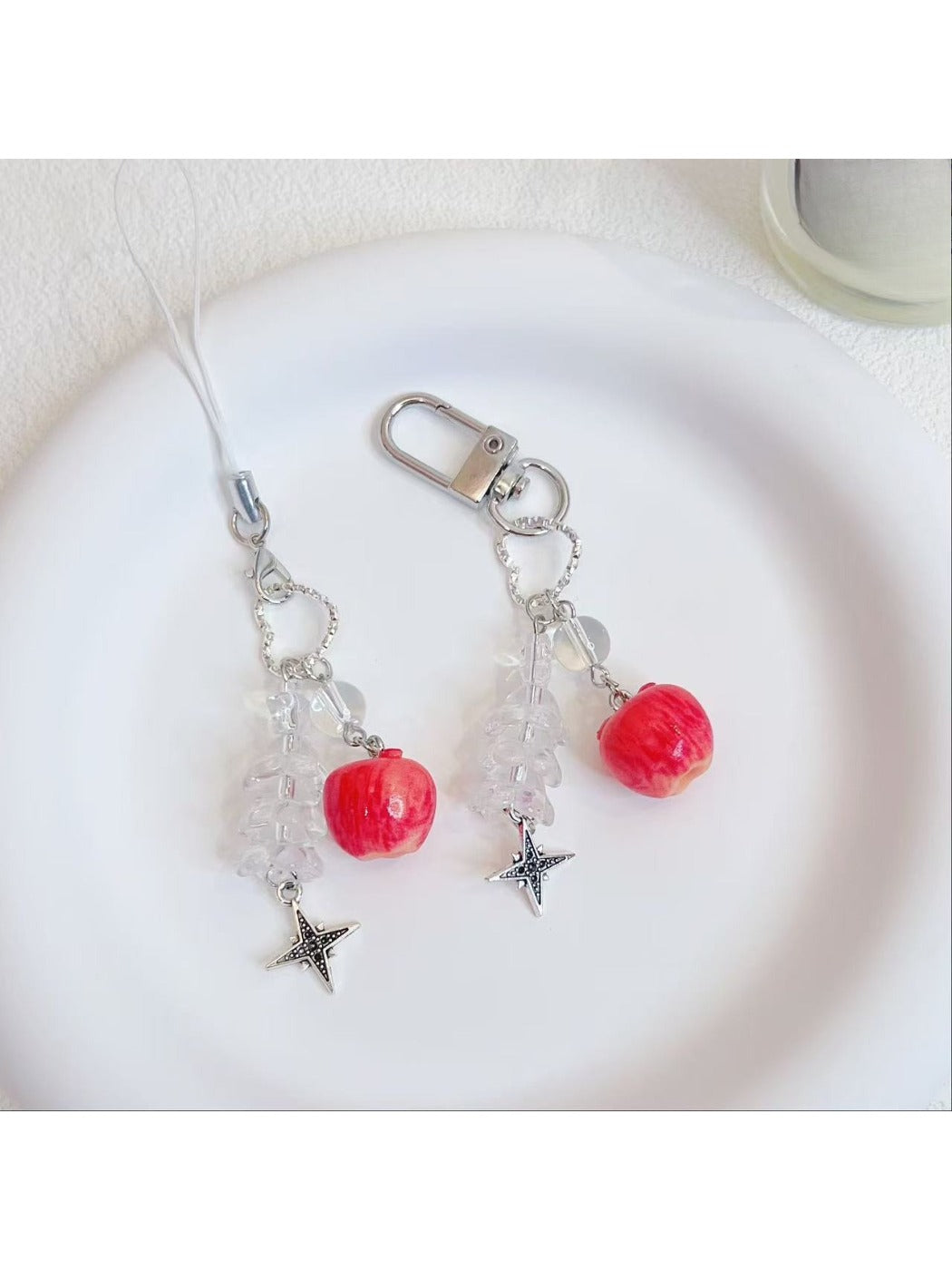 Close-up of the red apple keychain showing detailed texture and attached keyring