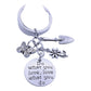 Butterfly flower keychain hanging from a bag zipper with natural light