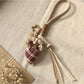 Fabric plaid strawberry umbrella keychain shown from a side angle