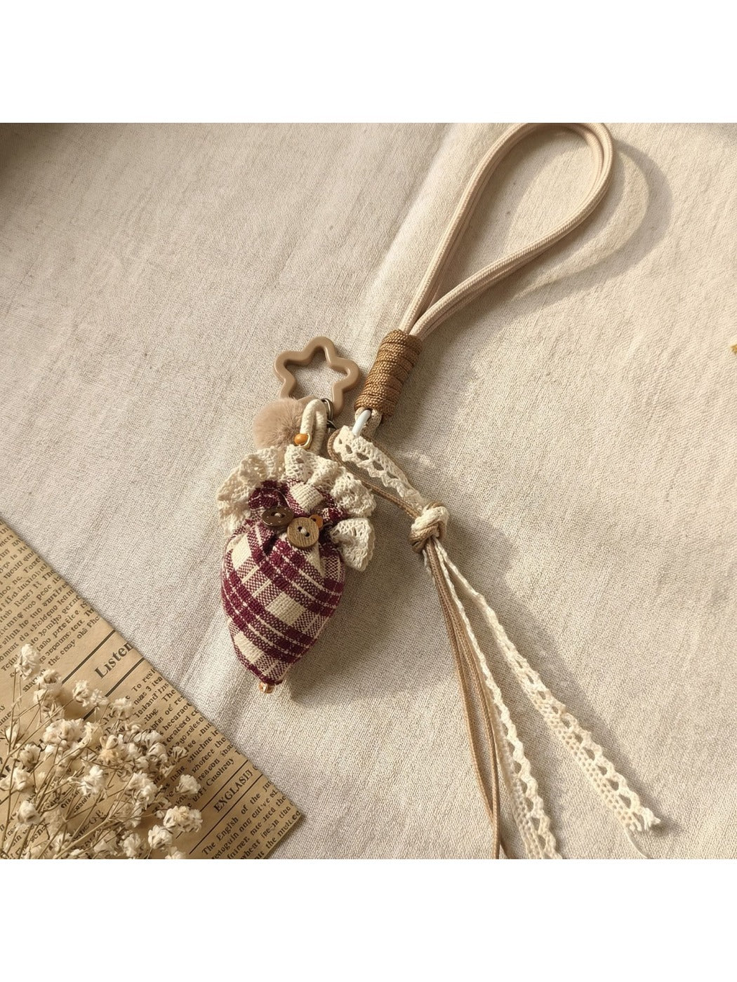 Fabric plaid strawberry umbrella keychain shown from a side angle