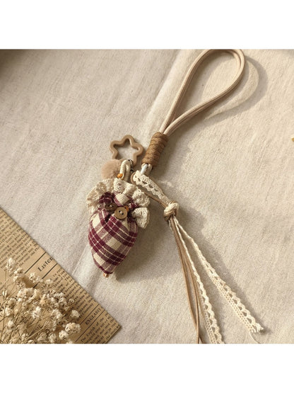 Fabric plaid strawberry umbrella keychain shown from a side angle