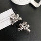 Beau classic bow hair clip worn in long brown hair styled in loose waves