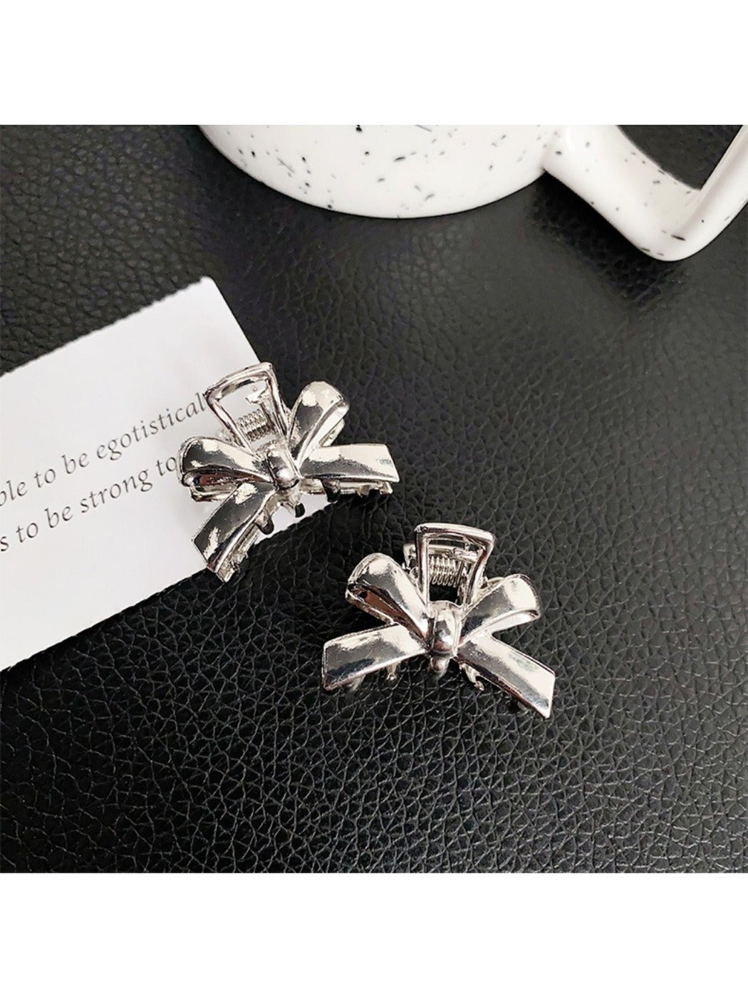 Beau classic bow hair clip worn in long brown hair styled in loose waves