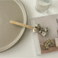 Beau bow bar hair clip in light beige acetate with subtle marbled pattern