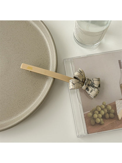 Beau bow bar hair clip in light beige acetate with subtle marbled pattern