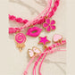Close-up of Lovra pink pendant layered bracelet showing detailed pink pendant and chain links