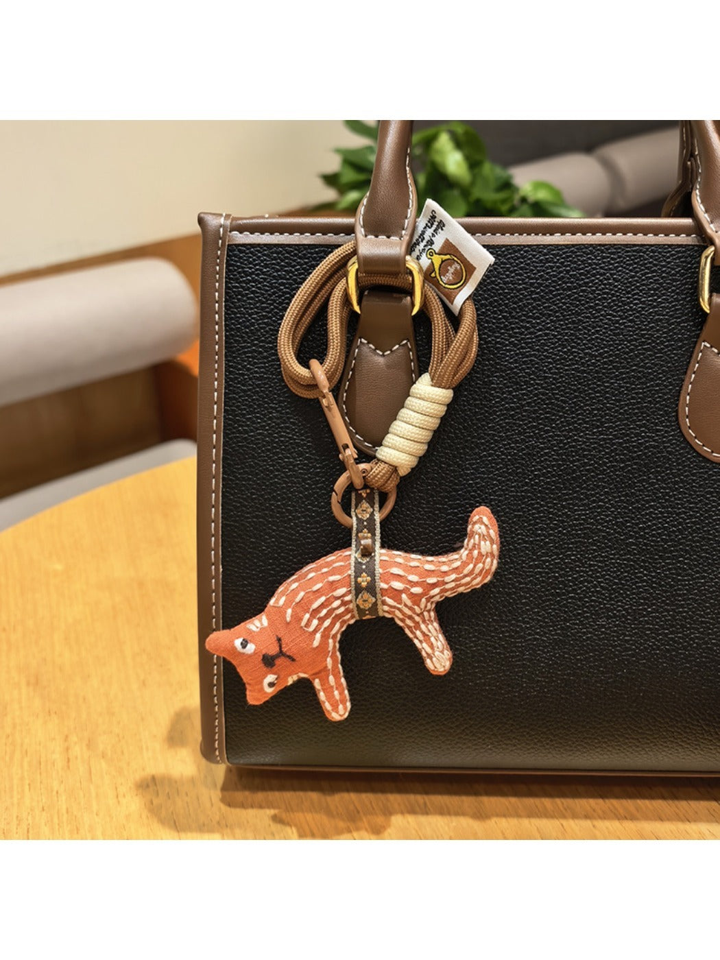 Fox charm keychain shown with a close-up of the metal clasp