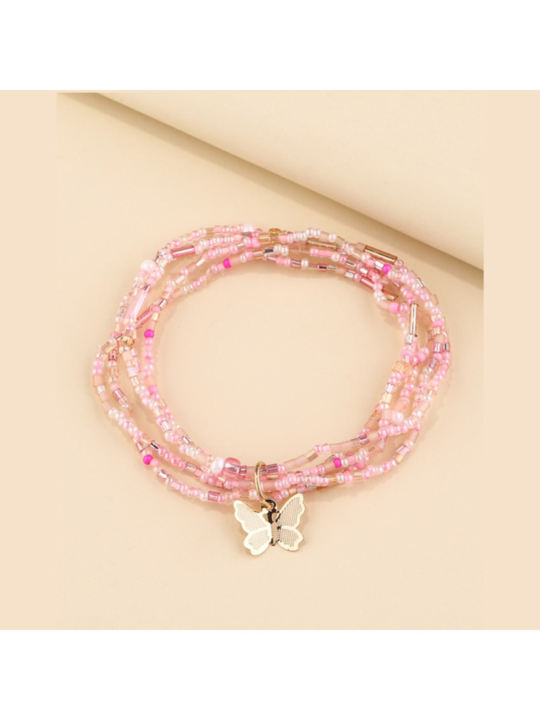Styled image of Lovra minimalist multi strand beaded bracelet with butterfly charm
