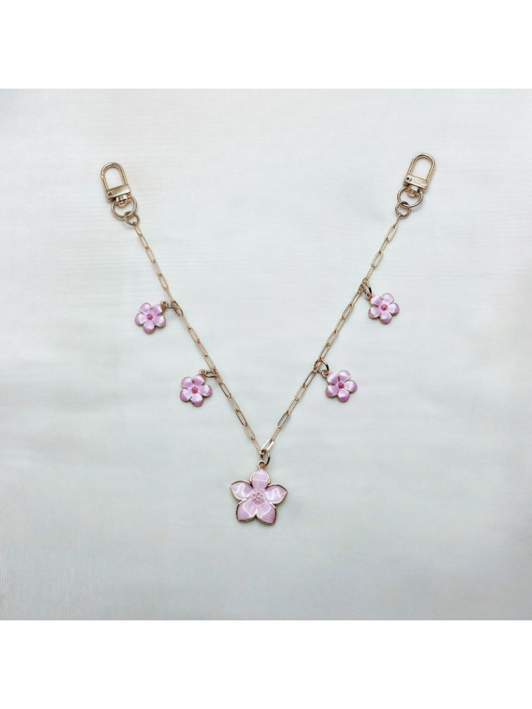 Cherry blossom pendant bag charm displayed on a white background with soft lighting