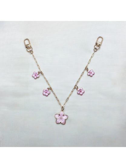 Cherry blossom pendant bag charm displayed on a white background with soft lighting