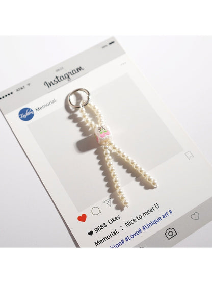 Keypus cute bow keychain placed on a wooden surface showing bead details