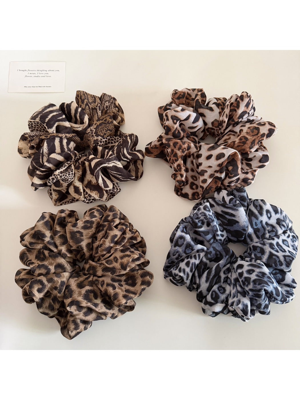 Close-up of vintage leopard print ruched scrunchie on white background