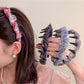 Close-up of Gifty floral print headband fabric texture and delicate flower pattern