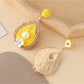 Earedge teardrop drop earrings displayed on a jewelry stand