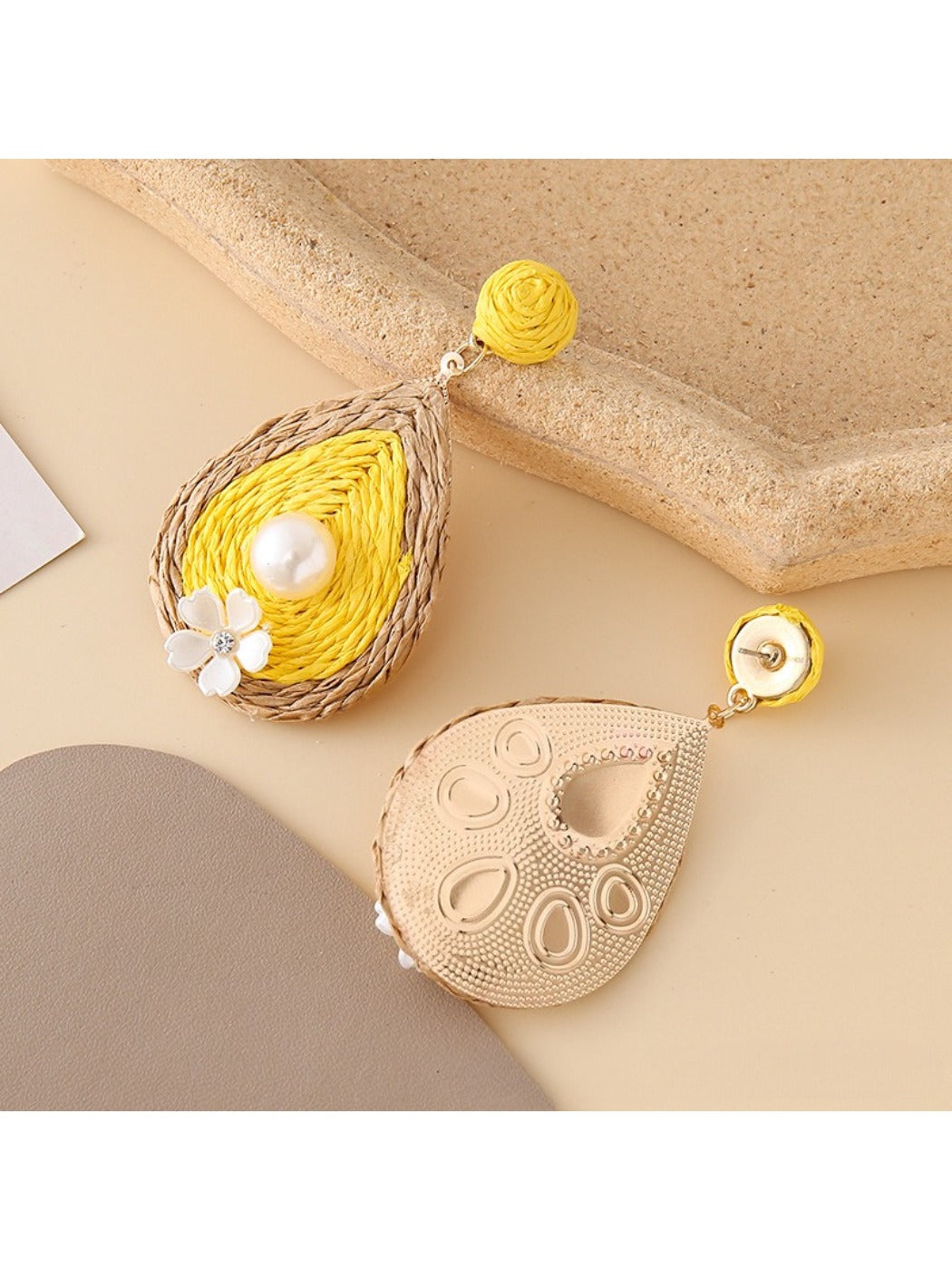 Earedge teardrop drop earrings displayed on a jewelry stand