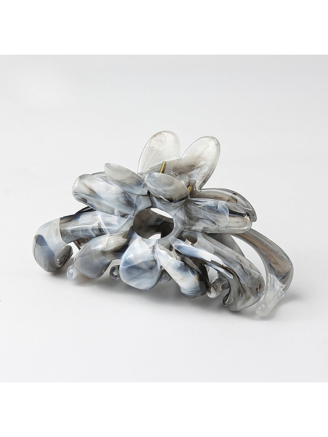 Side view of Beau flower hair clip on dark hair