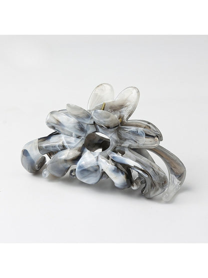 Side view of Beau flower hair clip on dark hair