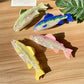 Beau elegant salmon shaped hair claw clip on white background