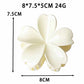 Beau claw clip held in hand displaying size and flower shape