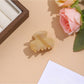 Beau vibrant acetate hair clip worn in styled hair with natural lighting