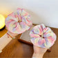 Side view of Gifty minimalist ruffled scrunchie highlighting its elastic band and fabric ruffles