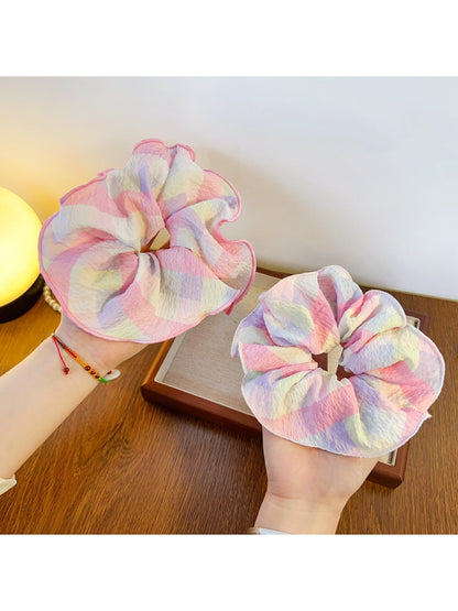 Side view of Gifty minimalist ruffled scrunchie highlighting its elastic band and fabric ruffles