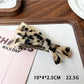 Beau elegant bow hair clip photographed from above showing symmetrical shape