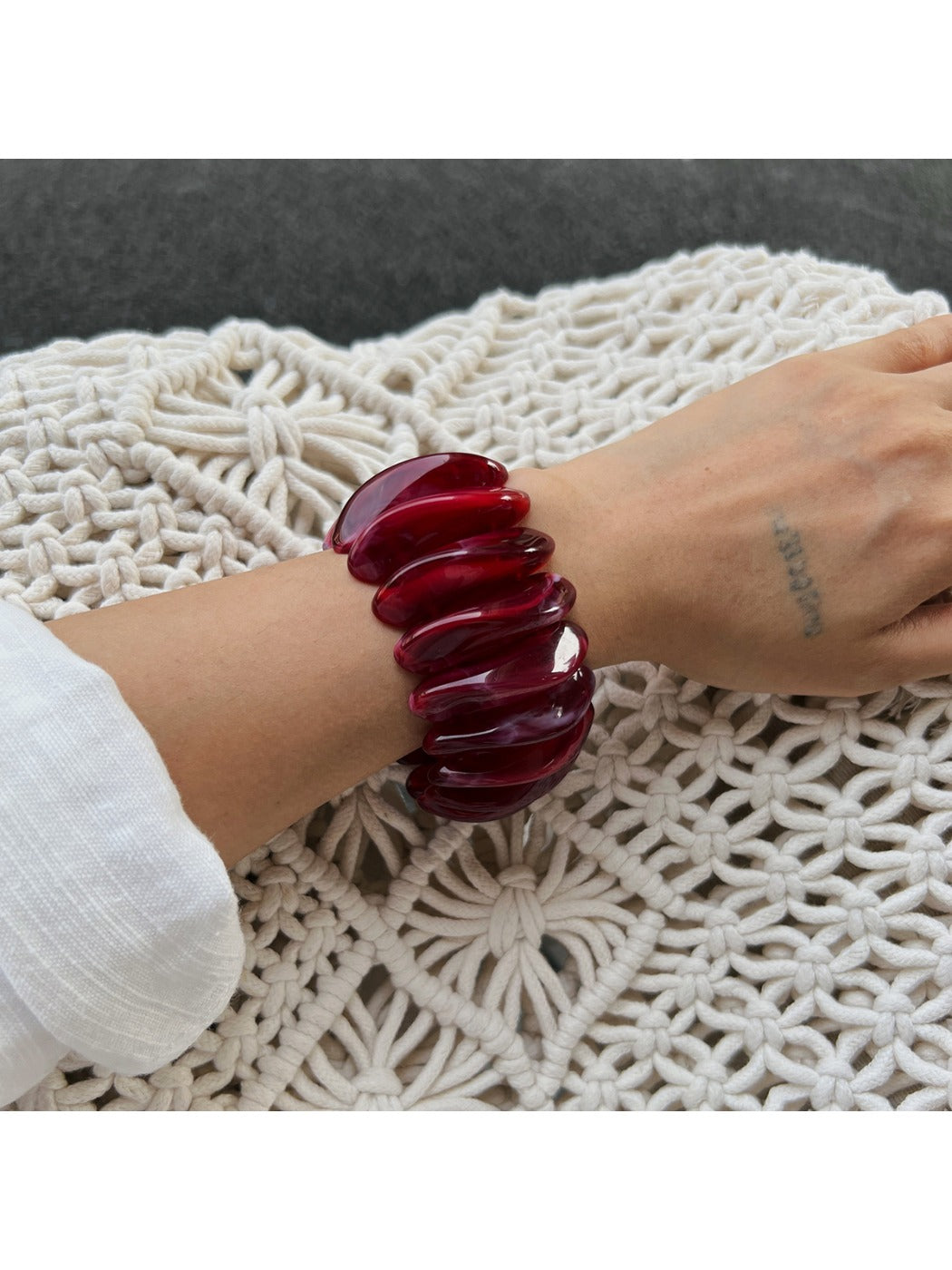 Lovra red ombre link bracelet and ring styled with casual outfit on model